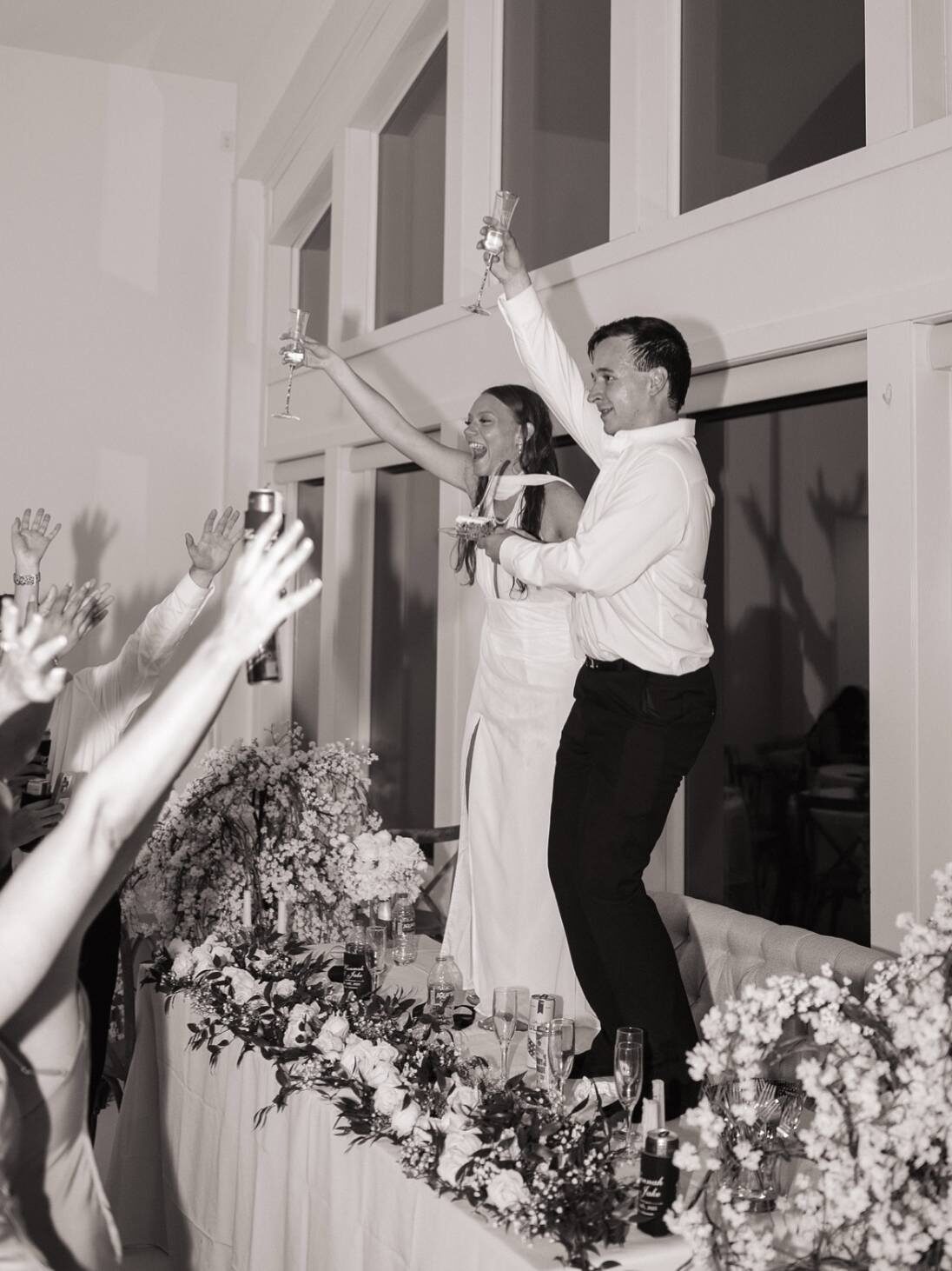 bride and groom dancing on table