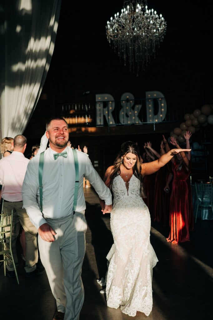 bride and groom entering wedding reception